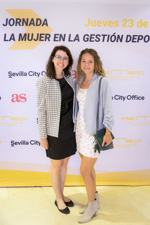 Two people pose at conference