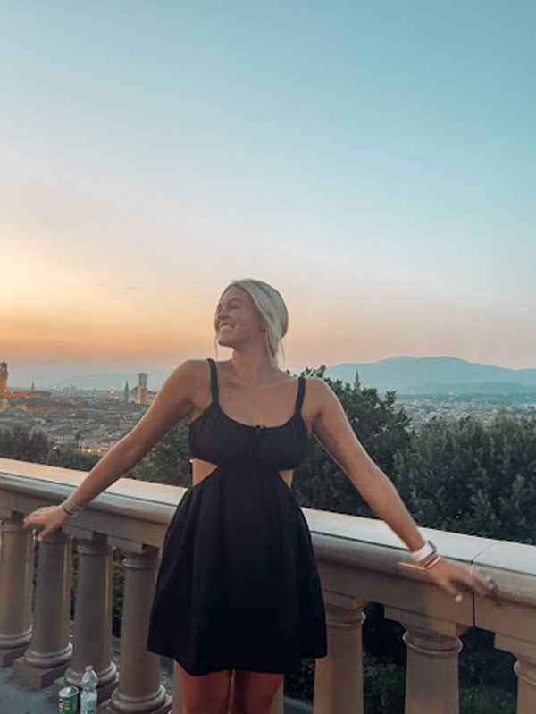 Student smiles atop view at Piazza Michelangelo