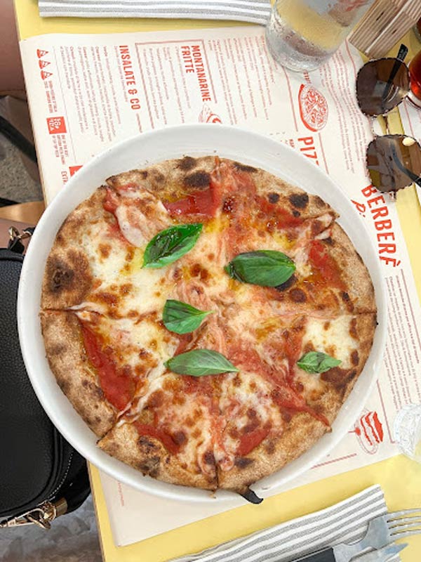 Delicious Pizza Pizza on a plate on top of menu