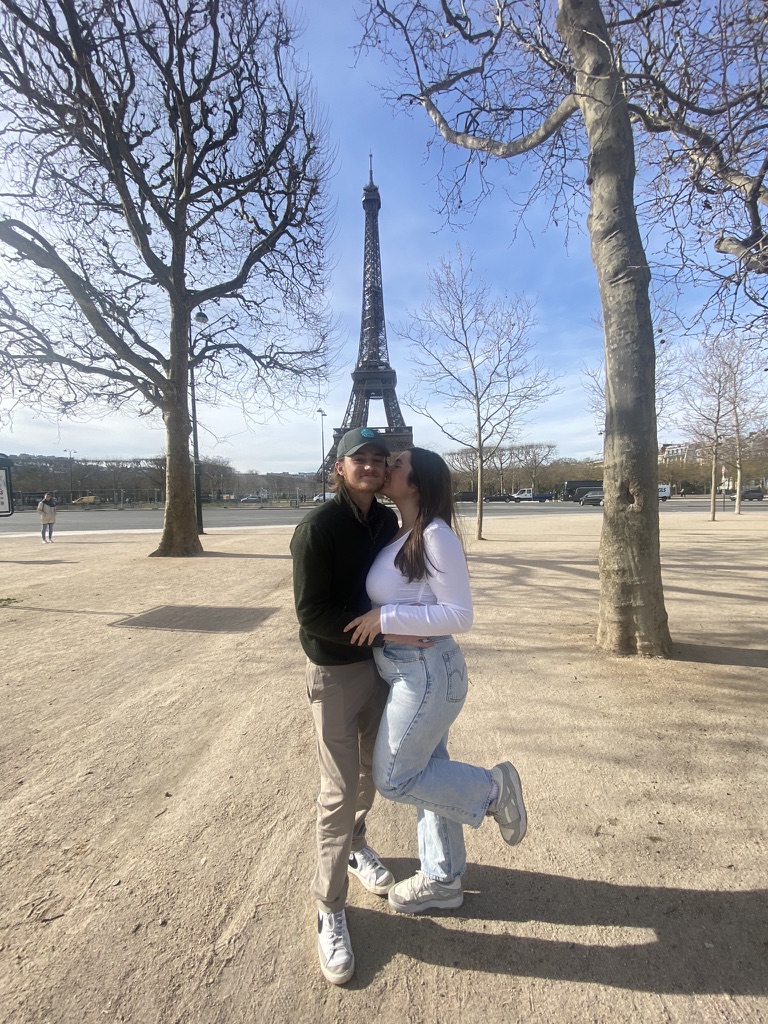 Couple posing in front of Eiffel Tower