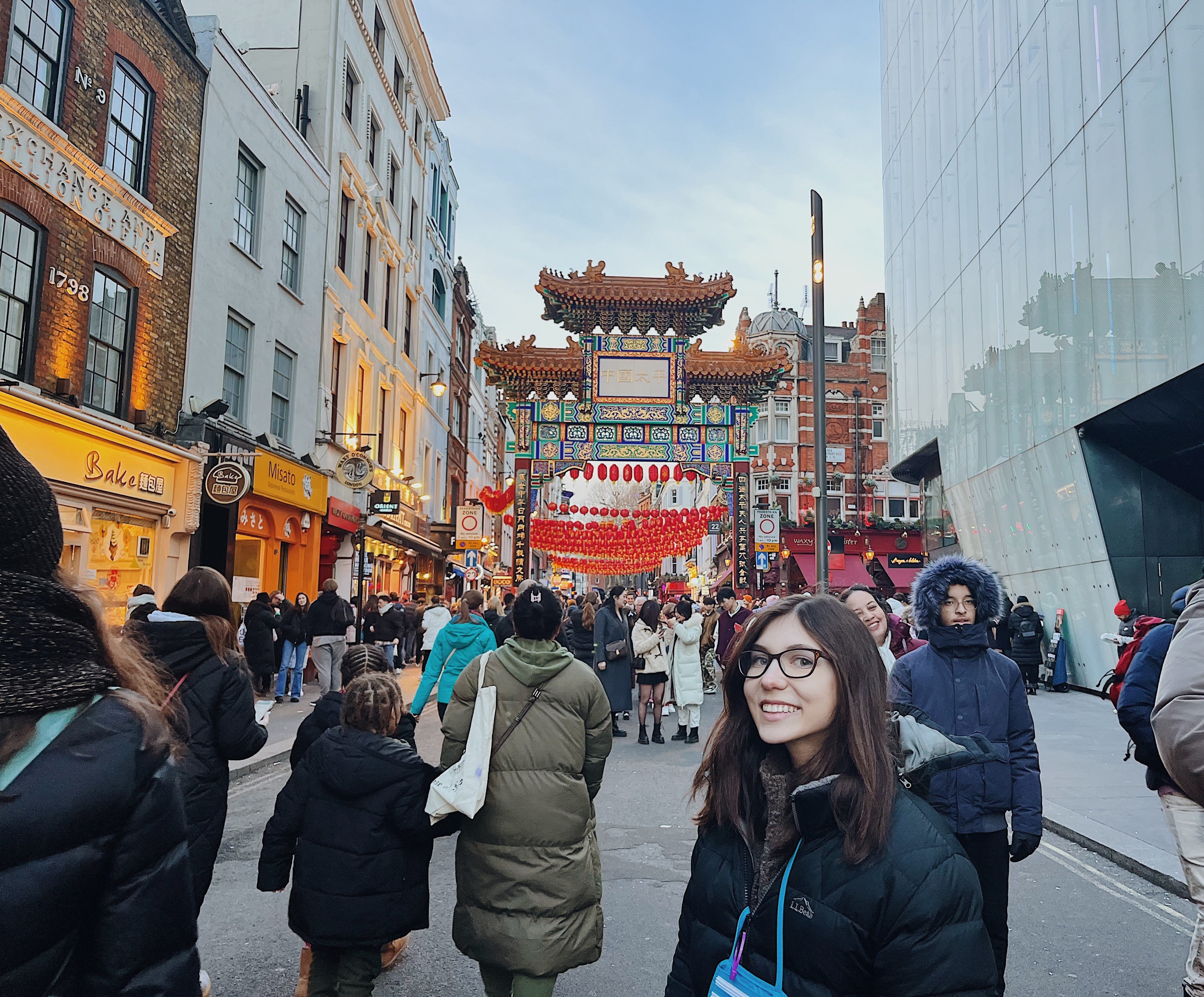 student posing in front of Chinatown crowd
