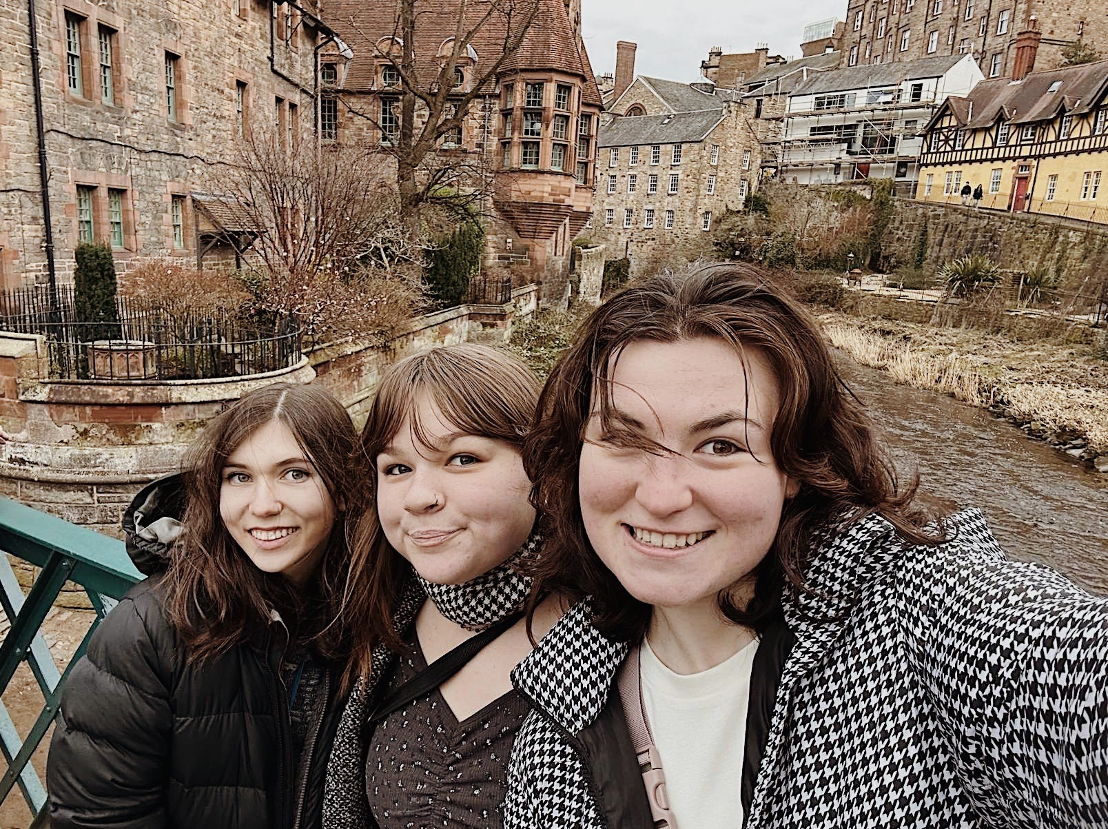 Friends smiling in front of buildings