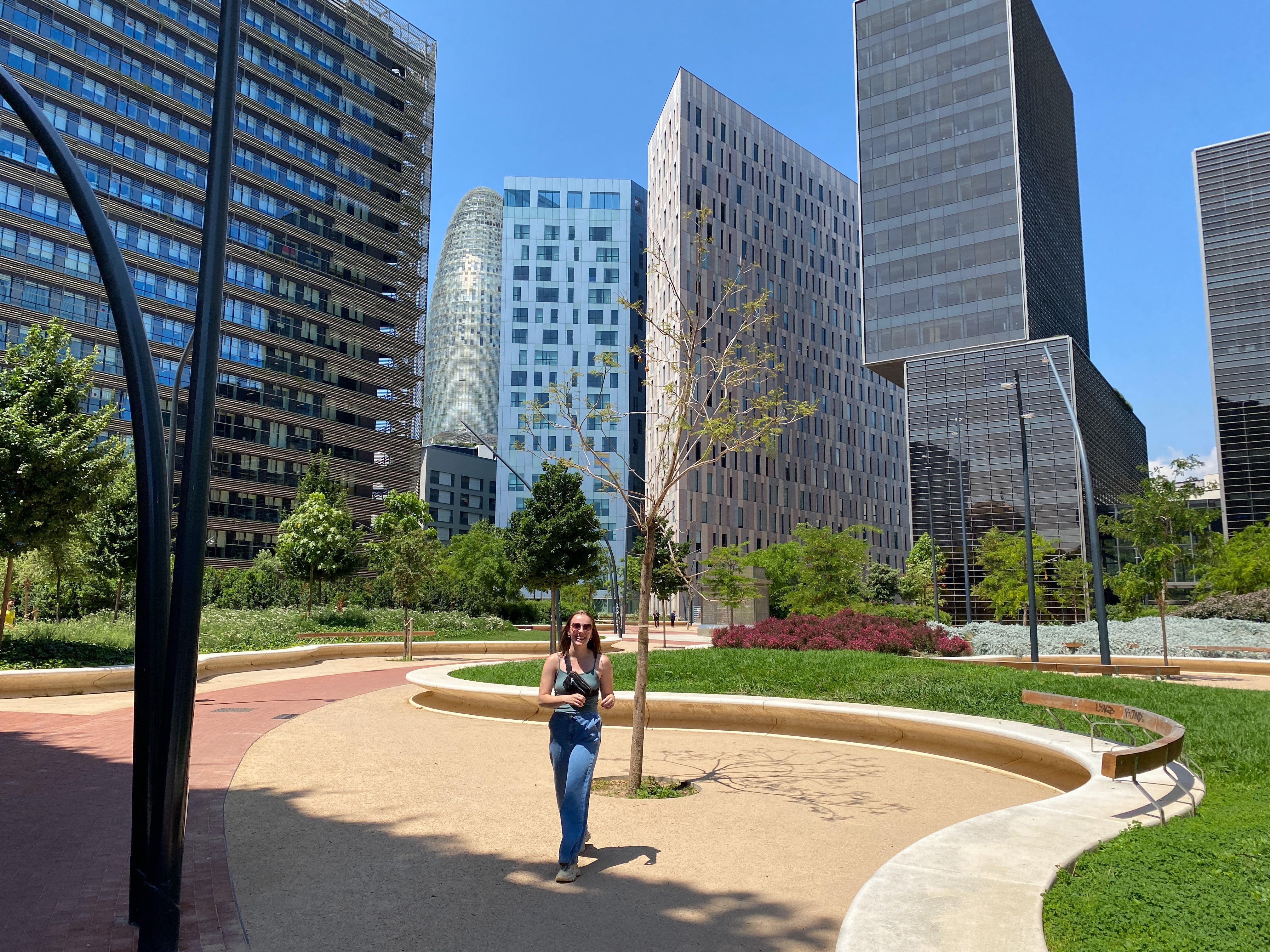 A person standing in front of corporate office buildings.