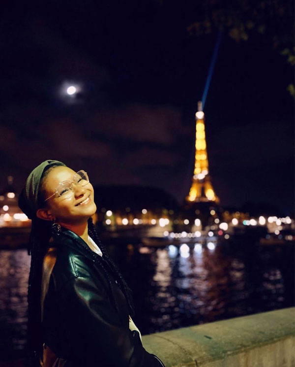 Pallas in front of lit up Eiffel Tower at night