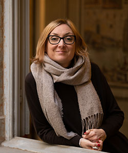A person wearing glasses and a scarf