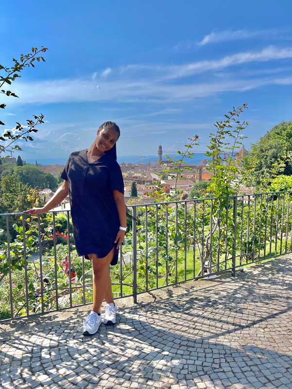 Student standing in front of Italian city view
