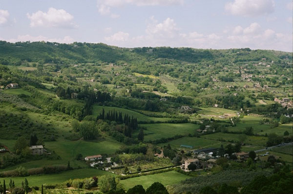 Rolling green mountains and dark sky in Italy