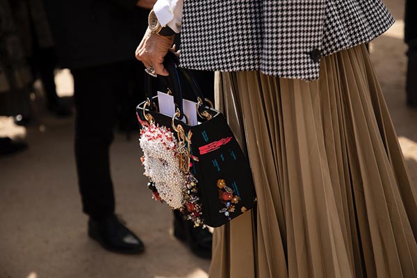 The Purse with the Face at Jardin des Tuileries during Paris Fashion Week 2022