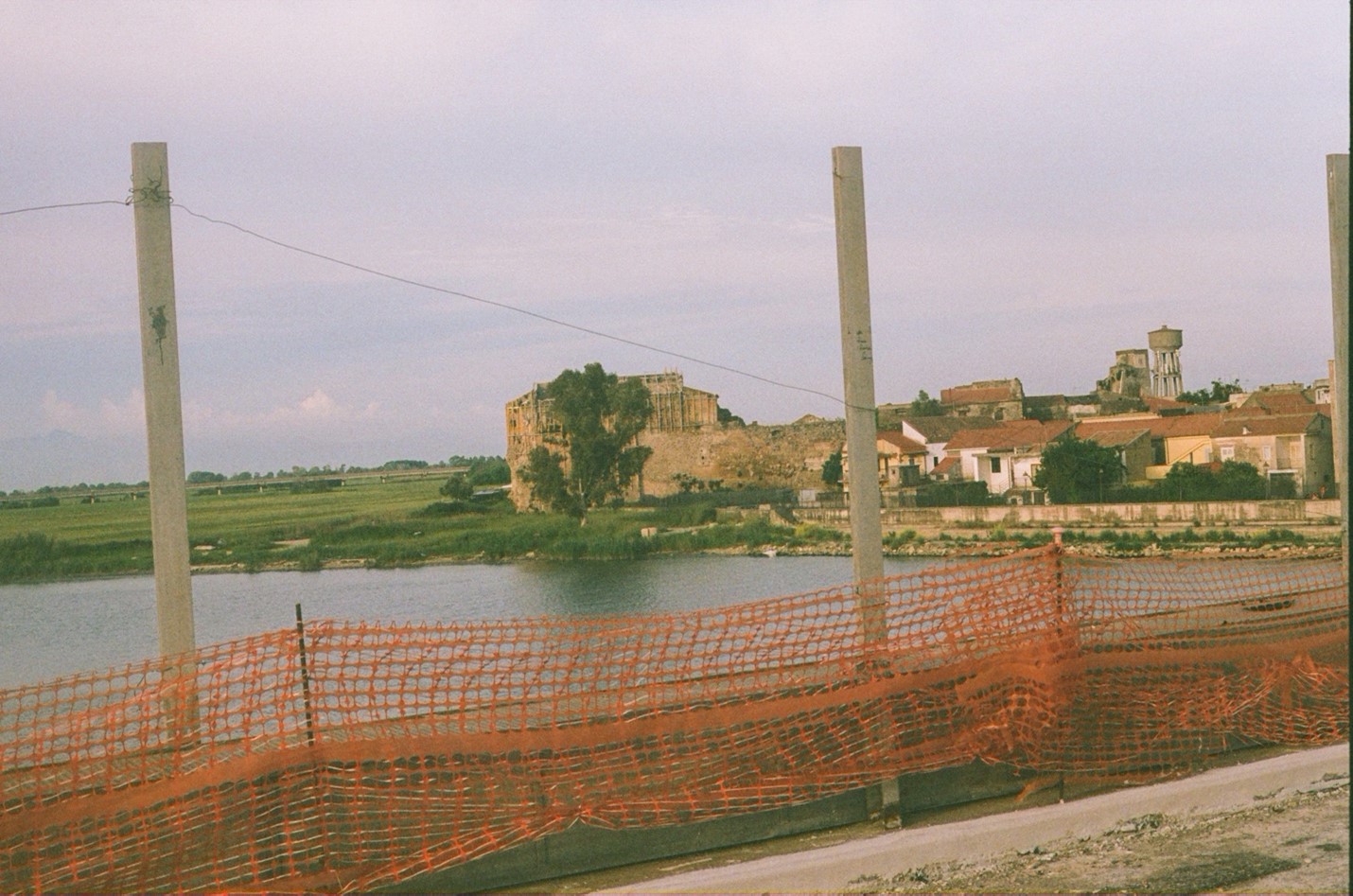 abandoned construction site near water and abandoned buildings