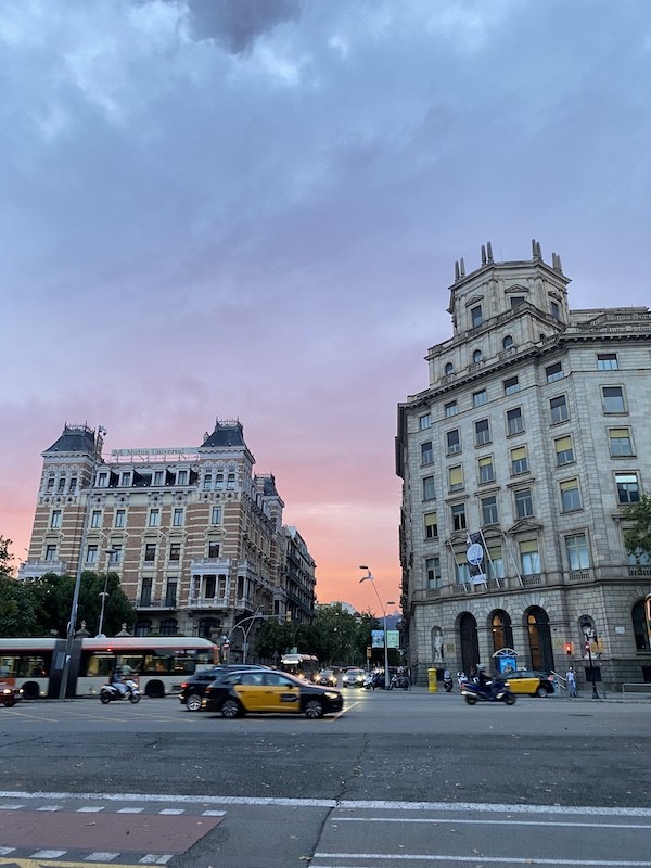 Sunset behind two buildings in Barcelona