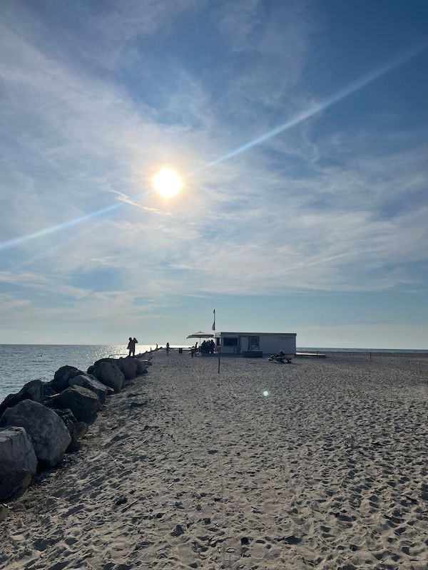 A restaurant in the distance on the beach.