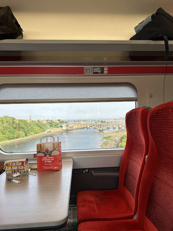 A view of the outdoors from a train window.