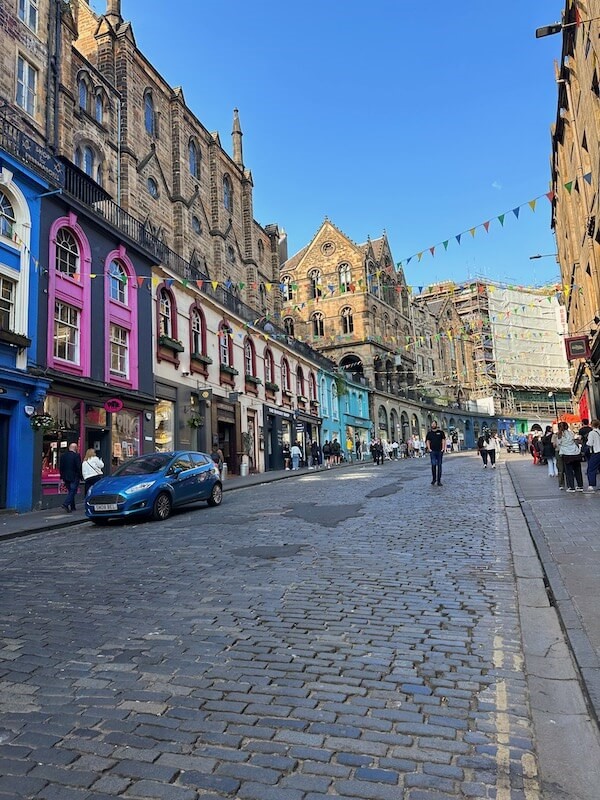 A brick road street surrounded by colorful buildings.