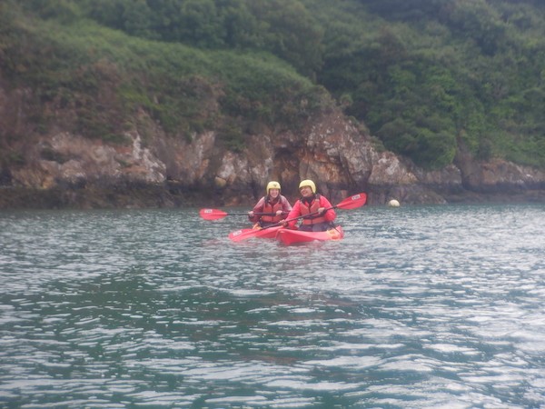 Two people kayaking along a river